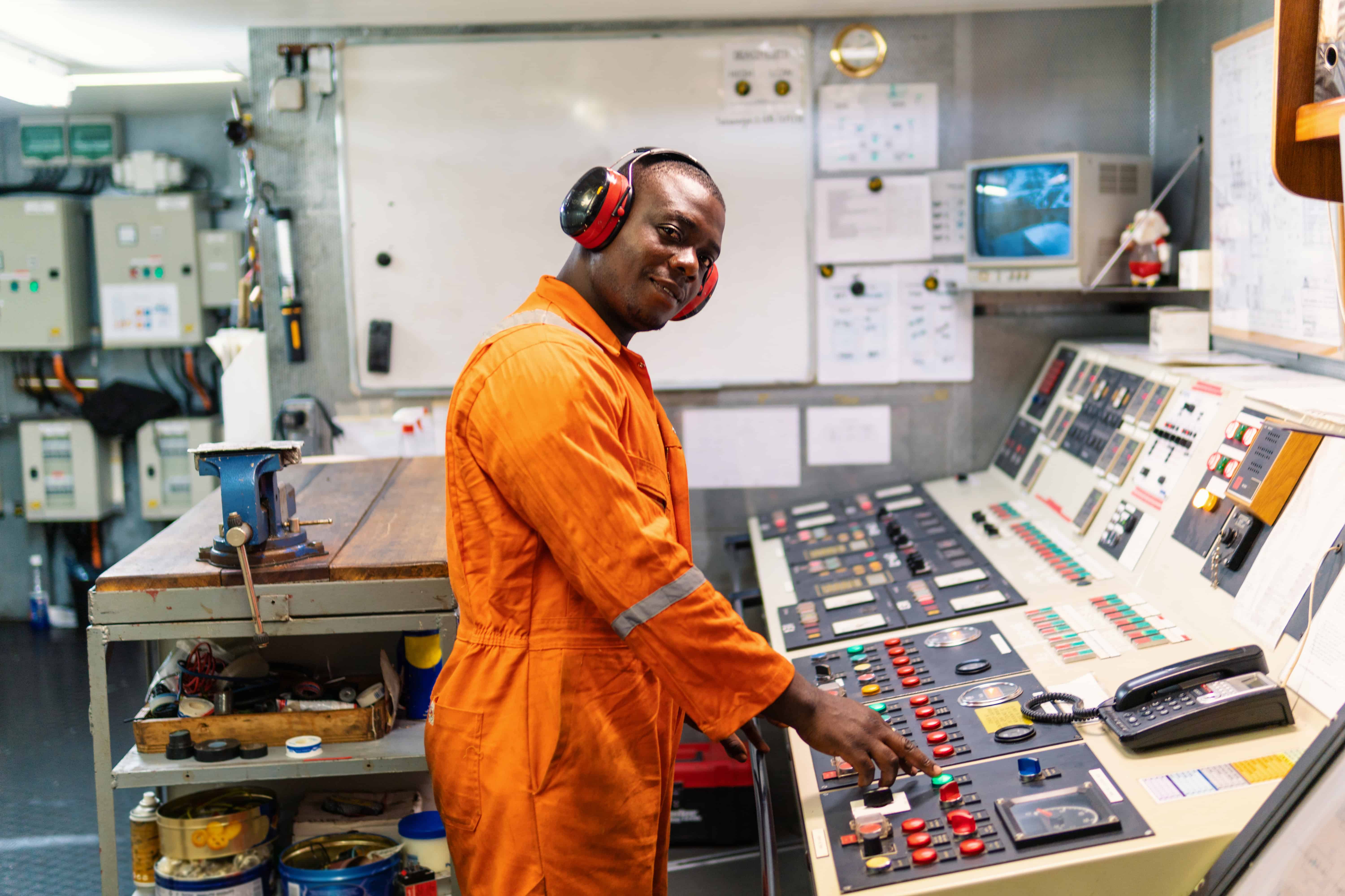 A worker at a control-room console monitoring operations.